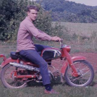 Thankfully my brother Bob captured me on my Honda sport 50, which I got as a basket case. I had to replace most of the front end including the stamped front fork. Actually I had to replace the fork twice after Larry Norris and I collided head-on on my parents driveway. : Alan Jones