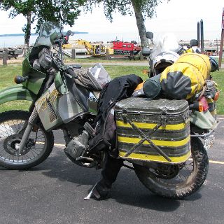 KLR with ammo cans for bags...must weigh a ton!