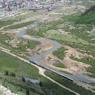 High country view of a D&R train making it's way into Silverton as another waits to depart for Durango.